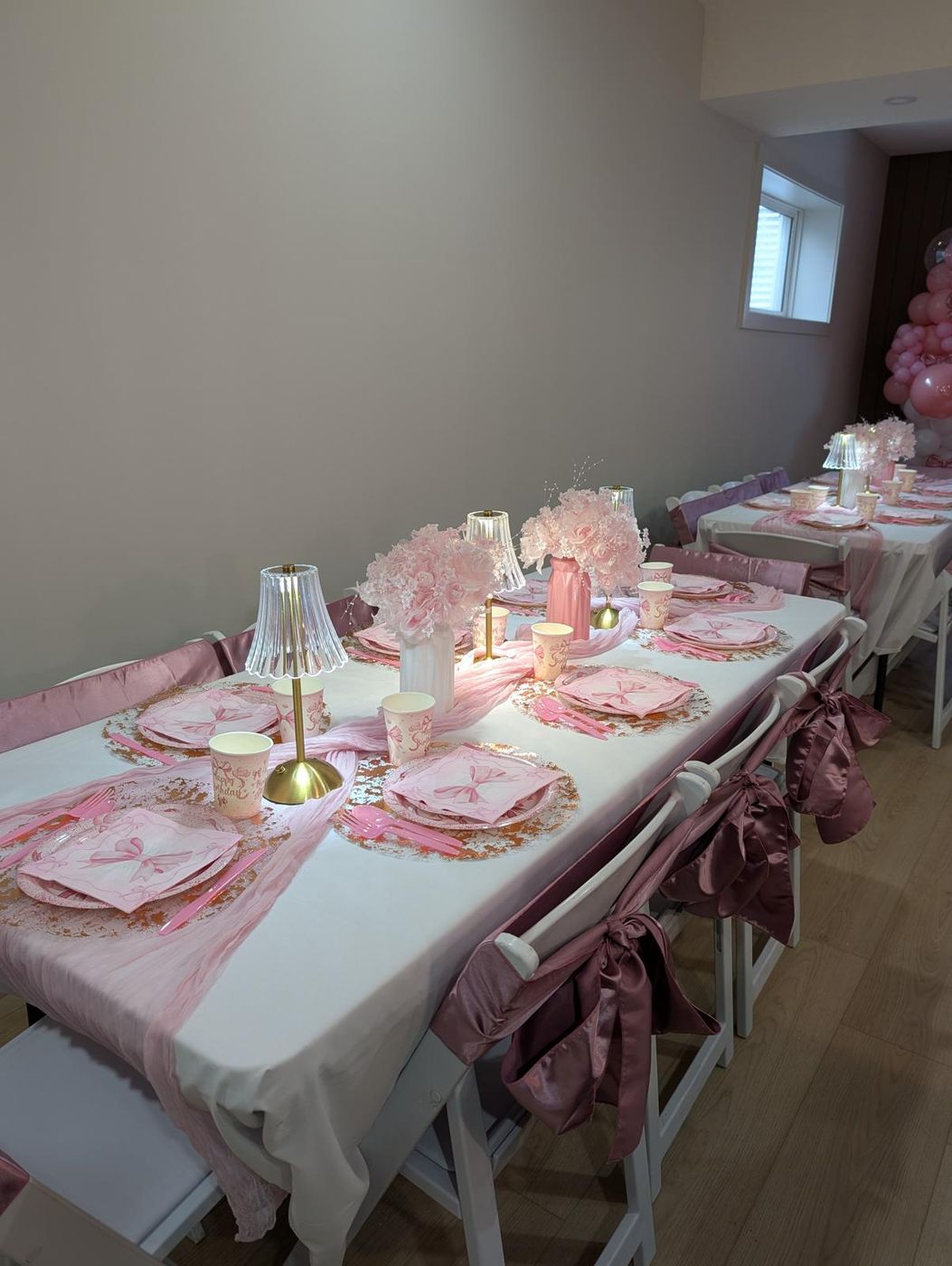 Blush party table with floral centerpieces and crystal lamps