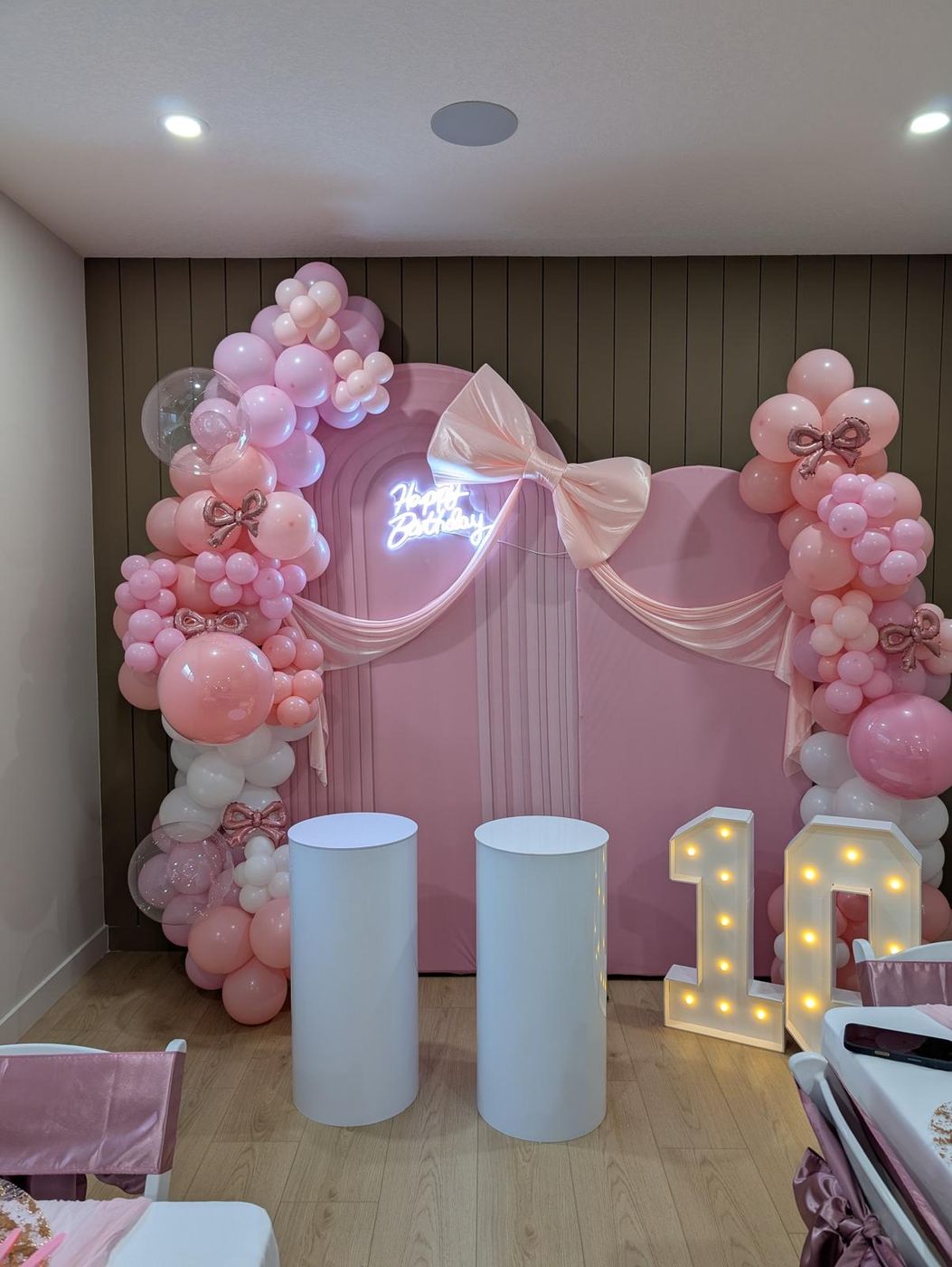 Pink backdrop with balloons and marquee number 10