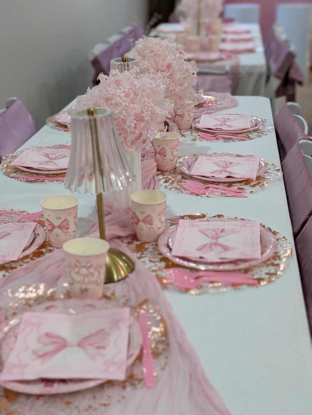 Pink place settings with bow napkins and rose gold chargers