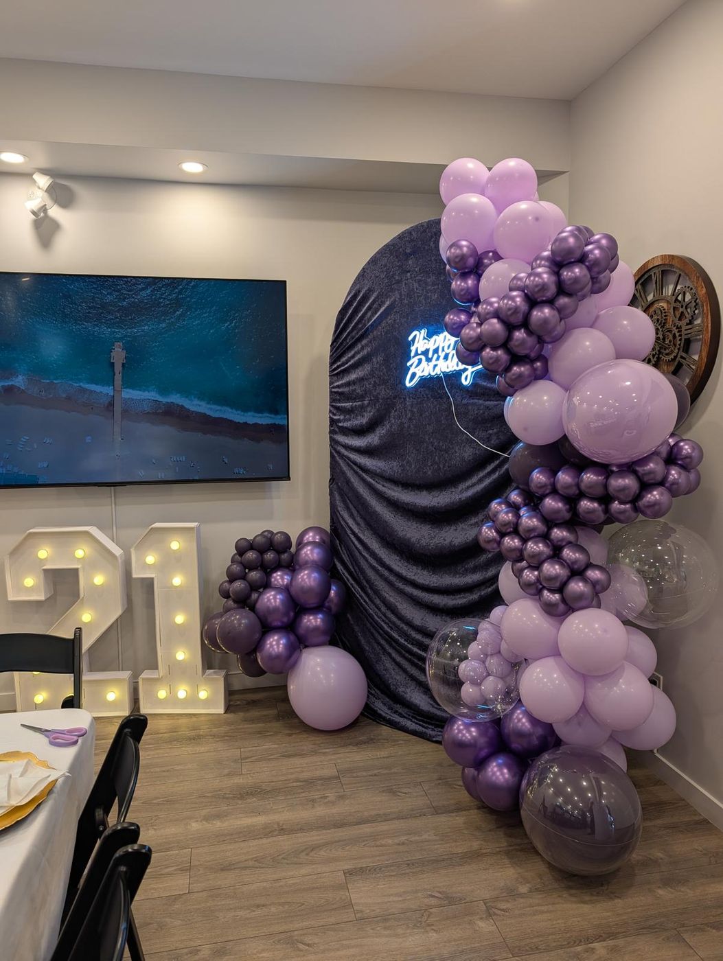 Long lavender dining table with gold chargers and purple florals