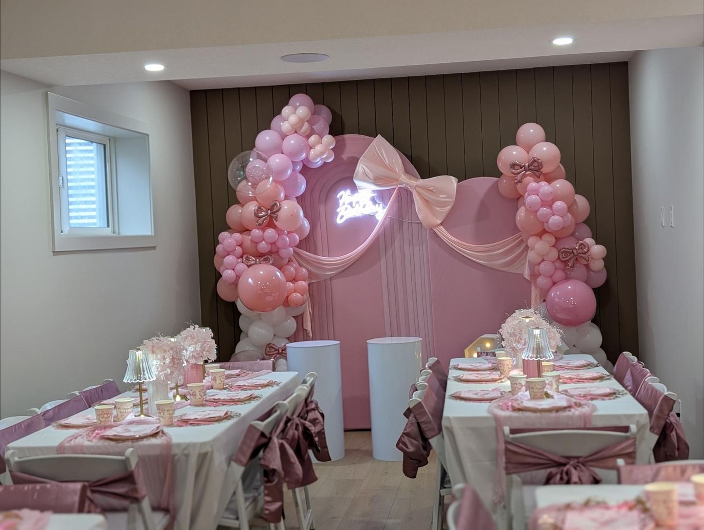 Pink kids party tablescape with satin bows on chairs